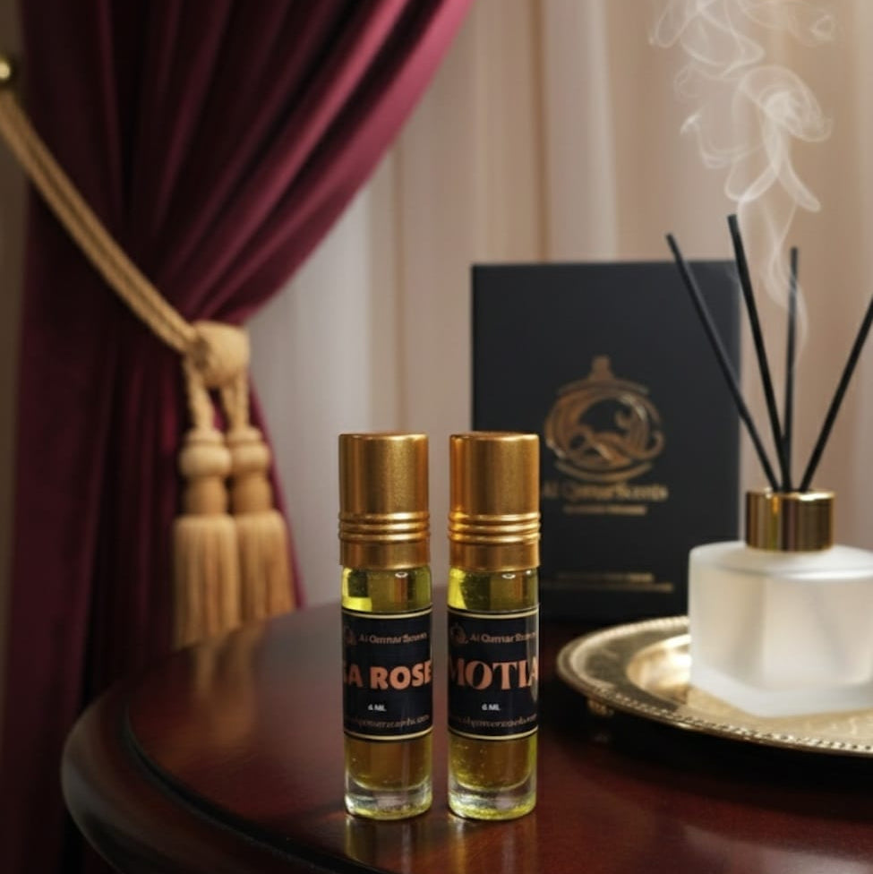Two perfume bottles labeled 'La Rosa' and 'Moto' on a table with a diffuser in the background.