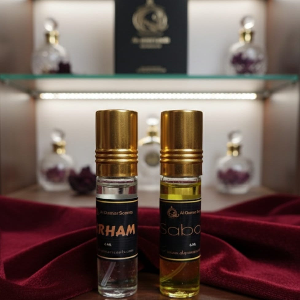 Two bottles of Al Rehab and Al Sabo perfume on a wooden surface with a blurred shelf in the background.