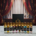 Set of perfume bottles with gold caps on a marble surface, with decorative curtains in the background.